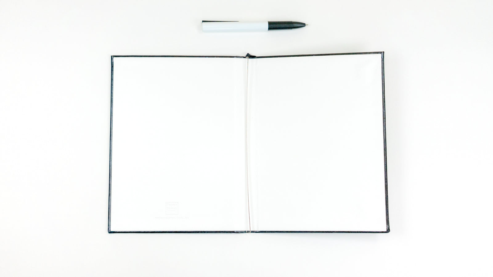 The Classic Paper Saver Reusable Notebook opened with its double sided vegan leather covers for extra durability and spill-resistance; spring steel binder designed to easily and conveniently insert and secure your used paper to write on the back blank sides, upcycling your paper and reducing your paper waste - a more sustainable way to write and live the eco friendly way.