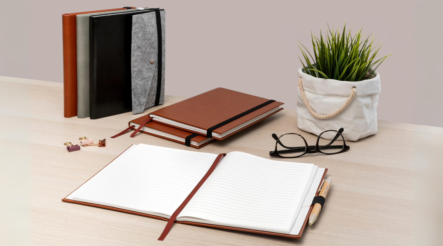 The Paper Saver Refillable Notebooks with Stone Paper Notebook Refills and eco stationery on a desk for sustainable living