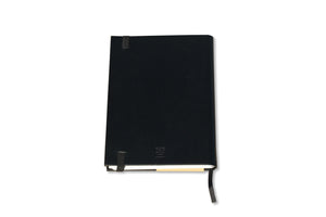 The Classic Paper Saver Notebook in black, shown on its back cover, is the only eco-friendly reusable notebook you need to write your notes and ideas while reducing paper waste.  Repurposing your used paper as pages, upcycle your paper to write notes sustainably. Replenish and reuse once done. Write comfortably and sustainably for zero waste living.