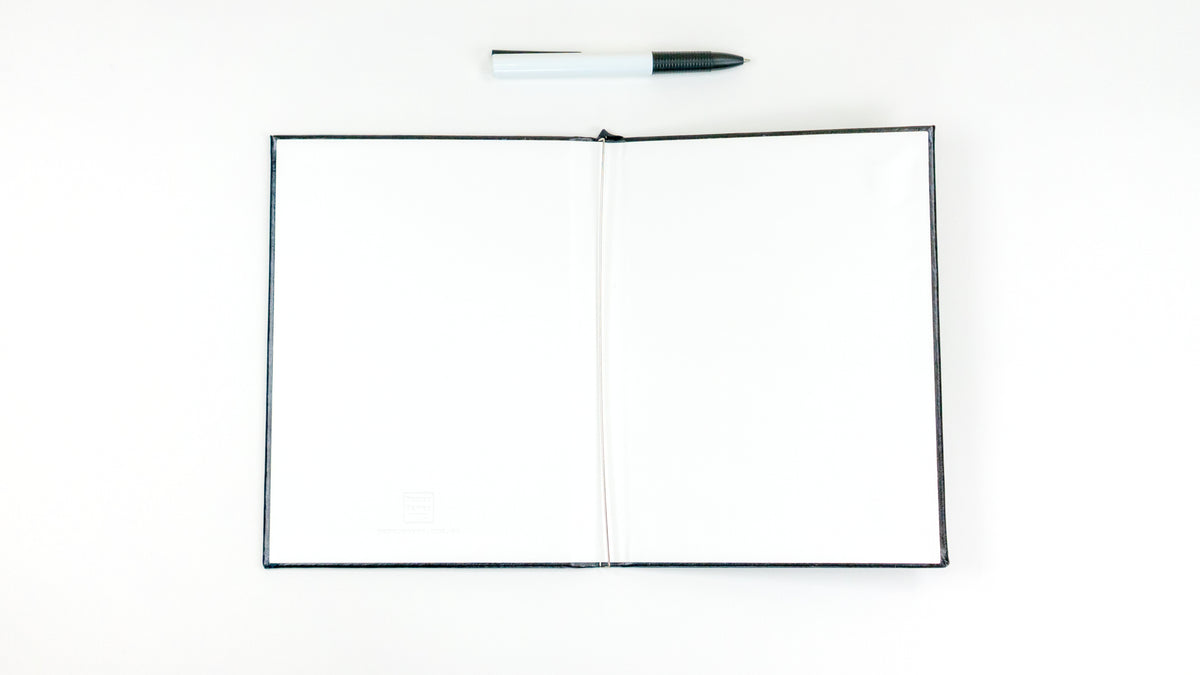 To use the Paper Saver Reusable Notebook, first open it to find the spring steel binder inside for the insertion of your used paper to be upcycled as pages of your eco friendly reusable notebook.