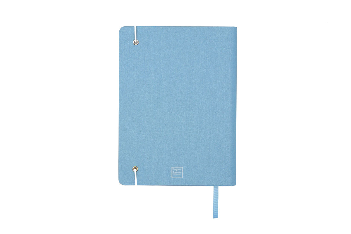 The Sparkle Paper Saver Notebook with canvas covers in blue, shown on its back cover, is the only eco-friendly reusable notebook you need to write your notes and ideas while reducing paper waste.  Repurposing your used paper as pages, upcycle your paper to write notes sustainably. Replenish and reuse once done. Write comfortably and sustainably for zero waste living.