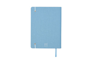 The Sparkle Paper Saver Notebook with canvas covers in blue, shown on its back cover, is the only eco-friendly reusable notebook you need to write your notes and ideas while reducing paper waste.  Repurposing your used paper as pages, upcycle your paper to write notes sustainably. Replenish and reuse once done. Write comfortably and sustainably for zero waste living.